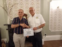 Ken Billington of Trade Aid presents certificate to Immediate Past President Mike Gicquel